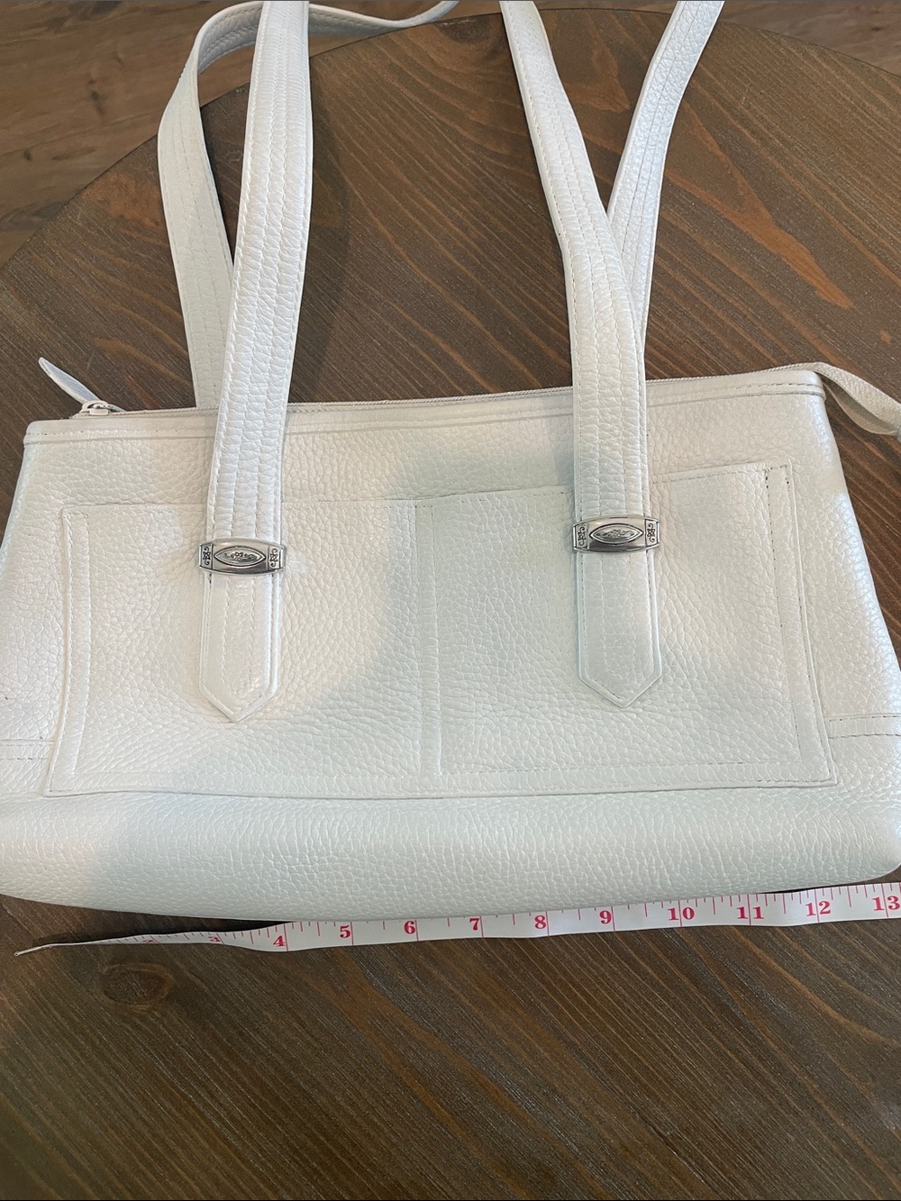 Brighton White Leather Shoulder Bag. Front Metal Hardware on two pockets.